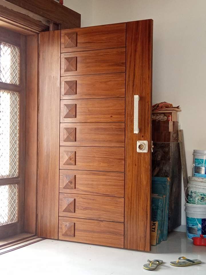 an open wooden door in front of a window next to some tools and other items