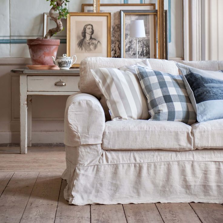 a living room filled with furniture and pictures on the wall