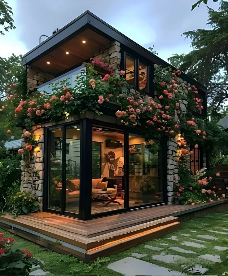 a small house with lots of flowers growing on it