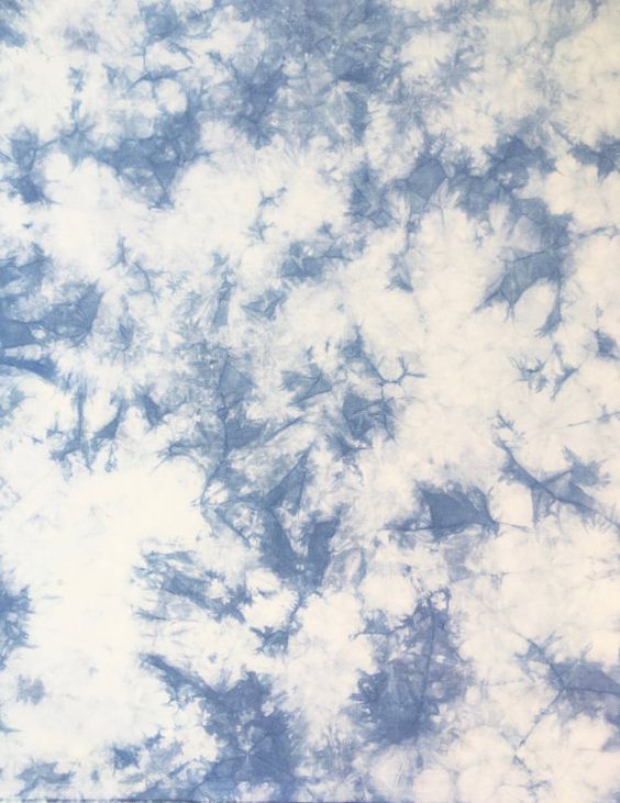 a blue and white tie dye background that looks like it has been dyed into something