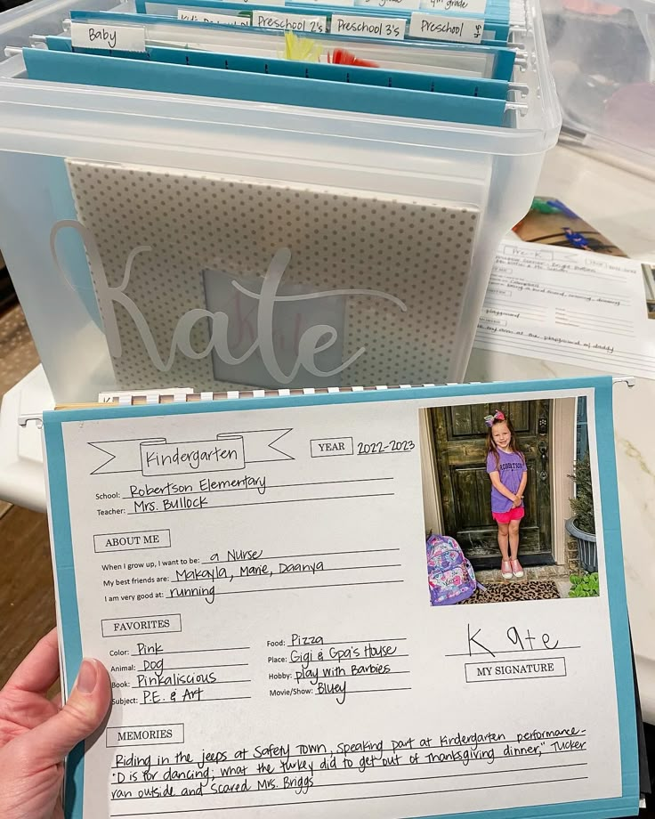 a person holding up a fake photo in front of a file cabinet with files on it