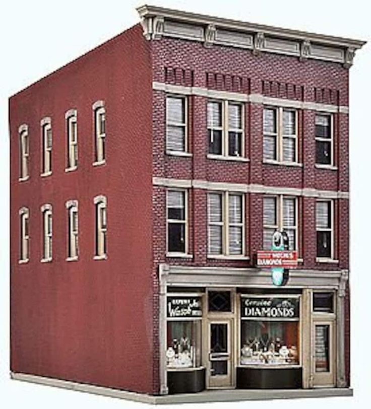 a tall red brick building sitting on the side of a road