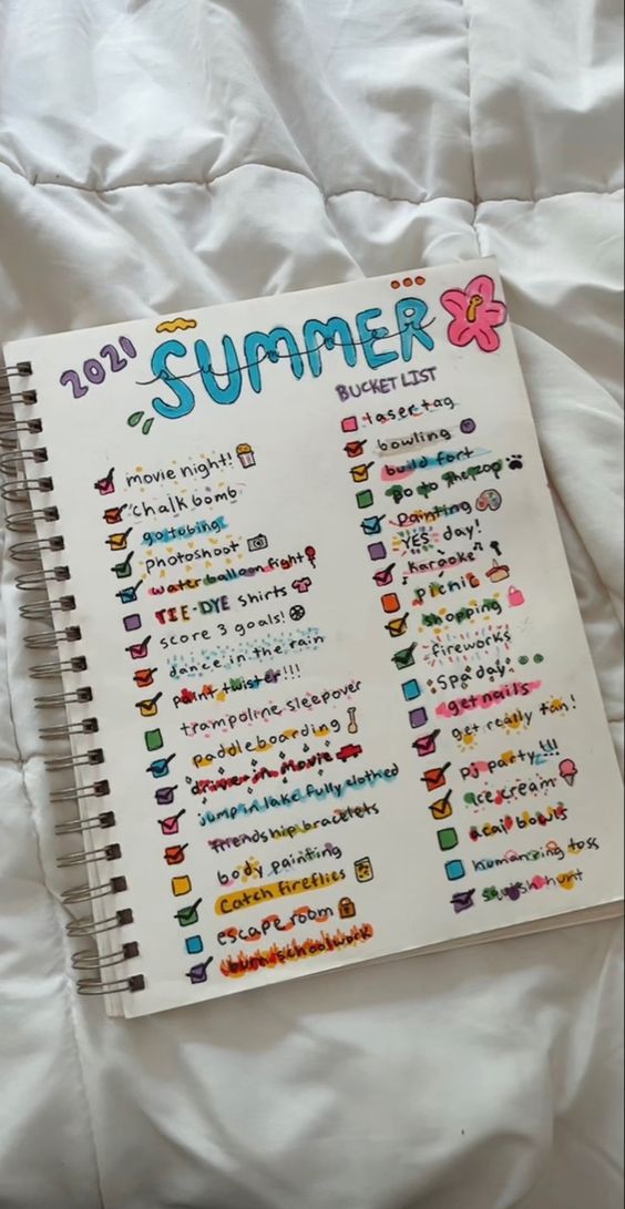 a notebook with the words summer written on it sitting on top of a white sheet