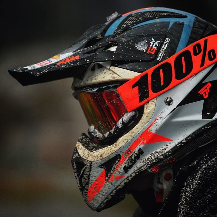 a helmet with the words 100 % written on it and an orange ribbon around the visor