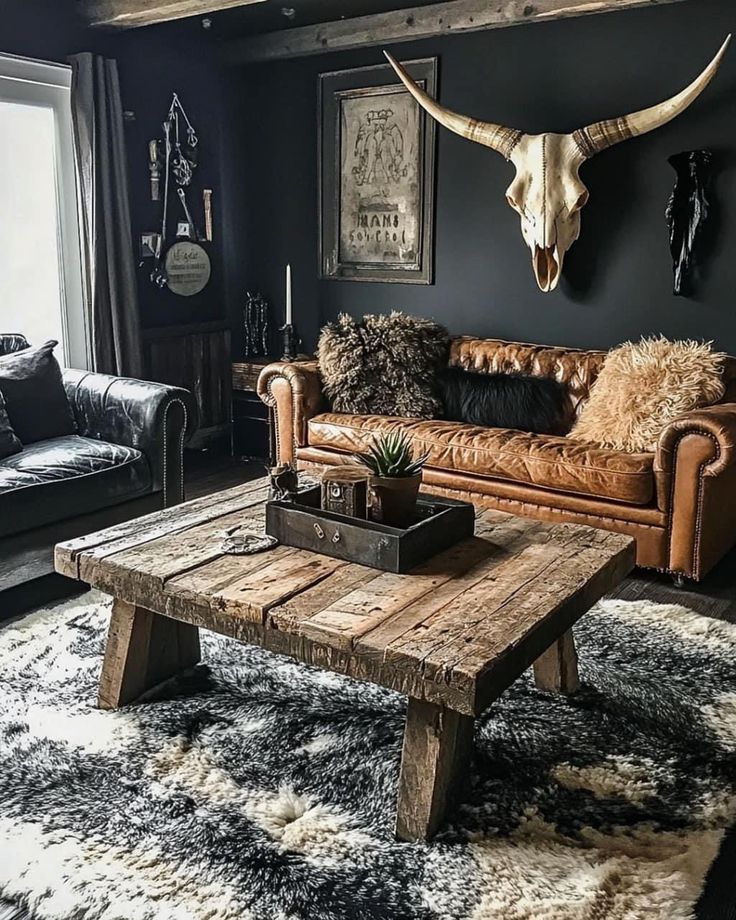 a living room filled with furniture and a cow skull mounted on the wall above it