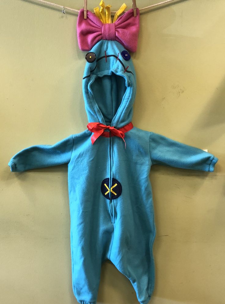 a baby's blue onesuit hanging on a clothesline with a red bow