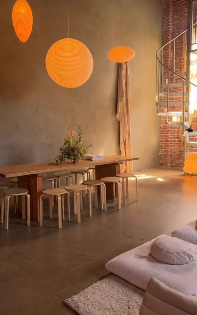 a living room filled with furniture and hanging lights