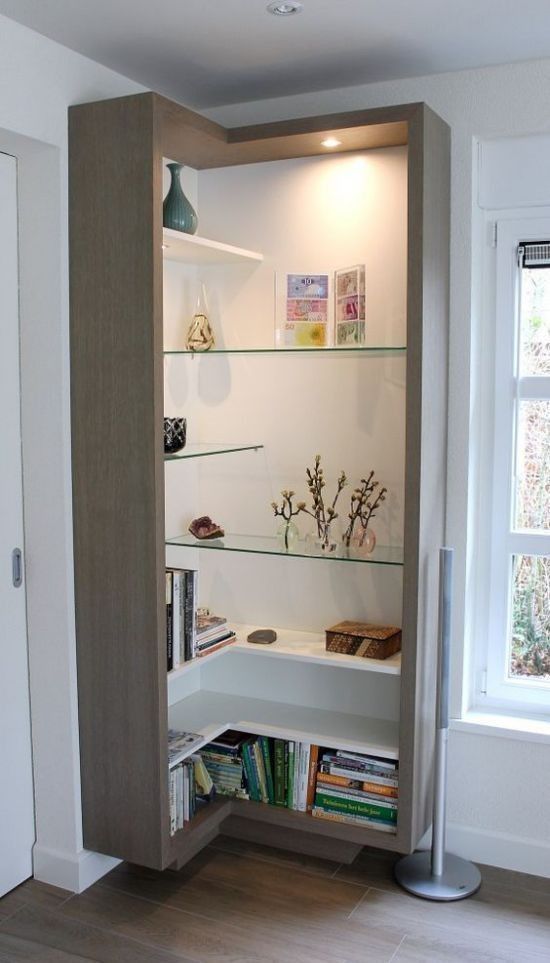 an open book shelf in the corner of a room