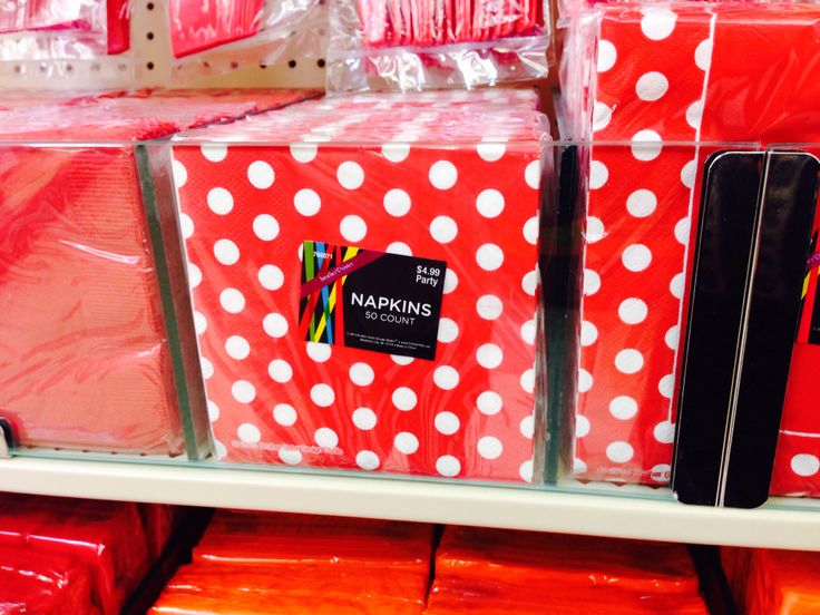 red boxes with white polka dots are stacked on the shelves in a store or department