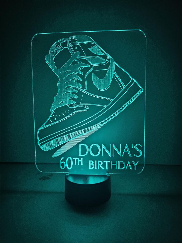 a neon light up sneaker with the name donna's 60th birthday on it