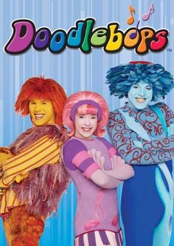 the three women are dressed up as doodlebops and one is holding a stuffed animal