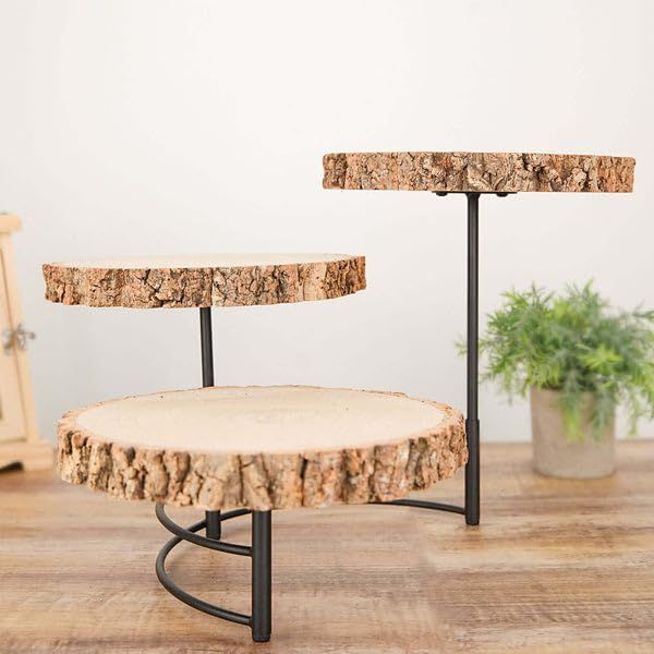 a table made out of tree slices on a wooden floor next to a potted plant