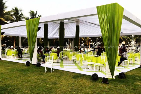 an outdoor event with tables and chairs set up