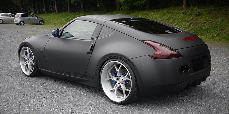 a gray sports car parked in a parking lot