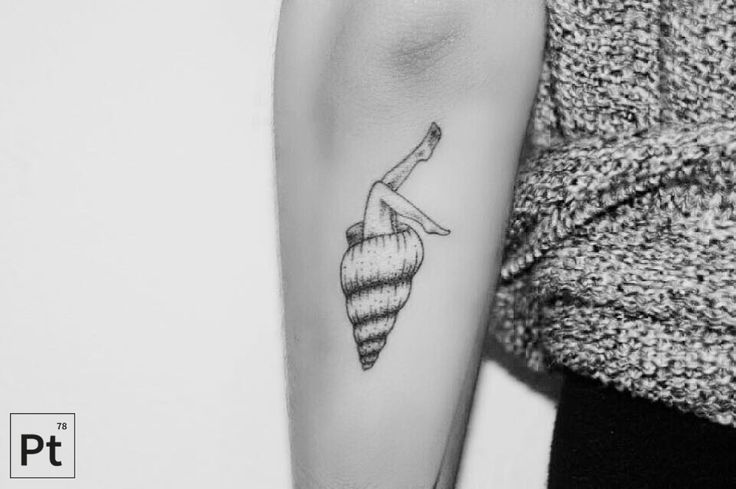 a black and white photo of a woman's arm with a tattoo on it