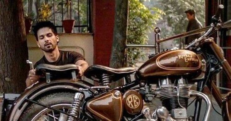 a man sitting on top of a brown motorcycle