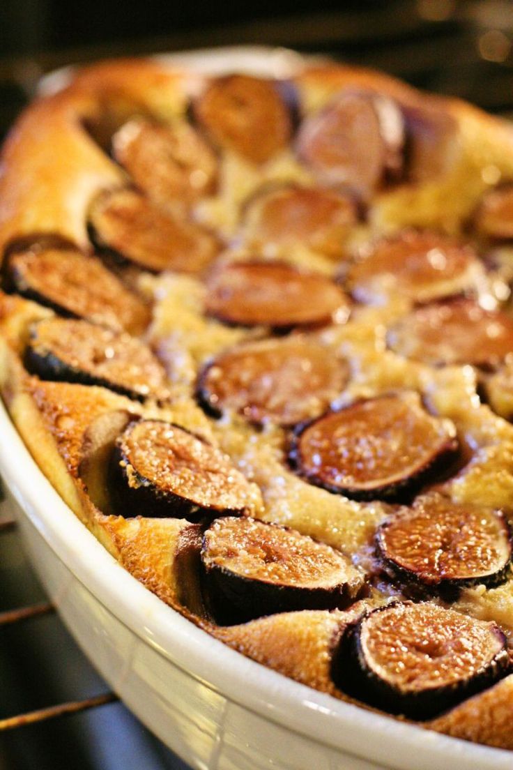 a baked dish in an oven with figs on the top and bottom, ready to be eaten