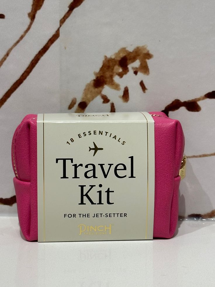 a pink travel kit sitting on top of a counter