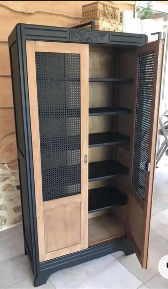 an open cabinet sitting on top of a tiled floor