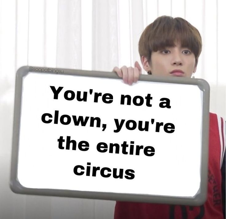 a boy holding up a sign with the words you're not a clown, you're the entire circus