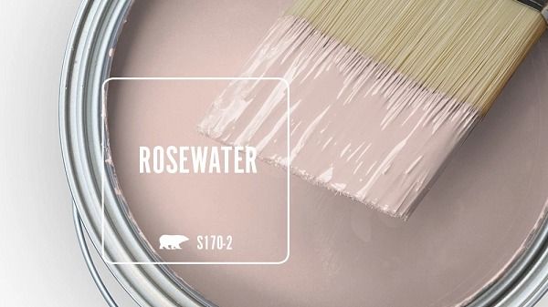 a paint can with a brush in it and the words rosewater painted on it