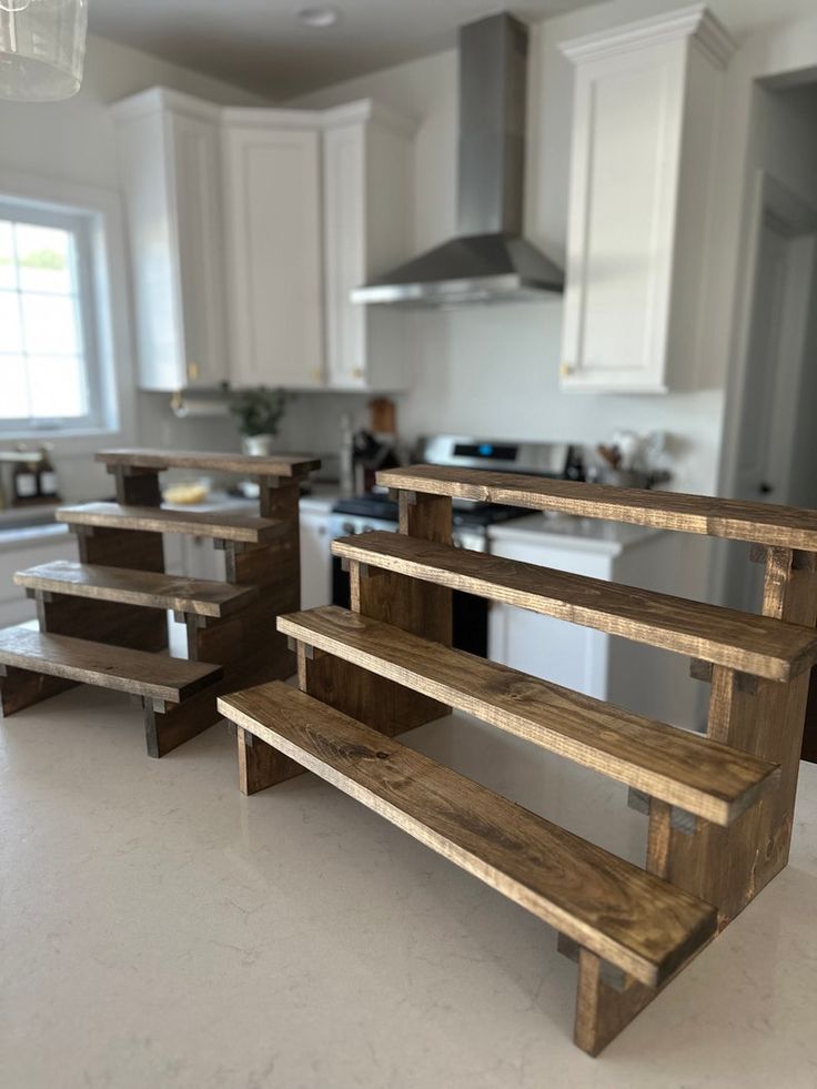 two wooden benches sitting in the middle of a kitchen