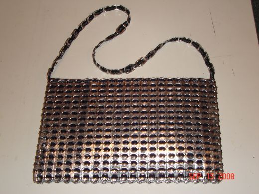 the purse is made out of metal mesh and has a long chain on one end