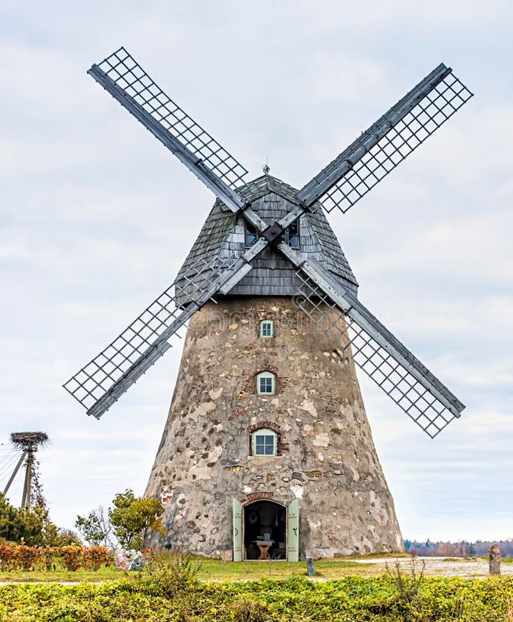 an old windmill in the middle of a field