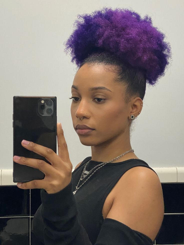 black woman with purple kinky, curly natural hair Purple Hair Dye On Black Hair, 4c Purple Hair, Purple Afro Hair Black Women, Purple 4c Natural Hair, Colours To Dye Your Hair Black Women, Violet Hair Black Women, Purple Natural Hair Black Women, Hair Dye Ideas For Black Women, Dyed Afro Hair