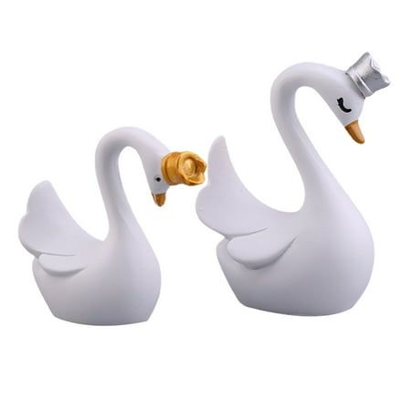 two white swans are standing next to each other on a white background with gold accents