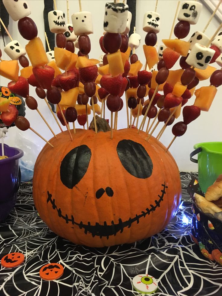 a pumpkin decorated with marshmallows and other halloween treats