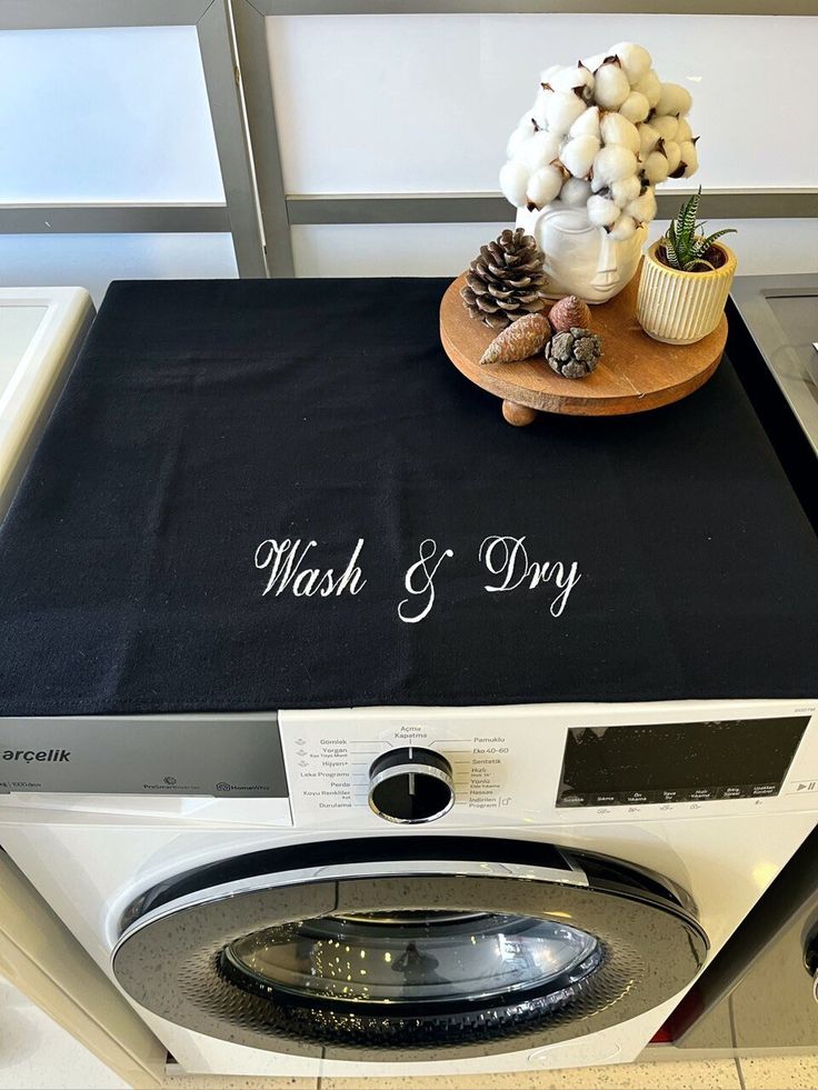 a washer and dryer sitting next to each other on top of a counter