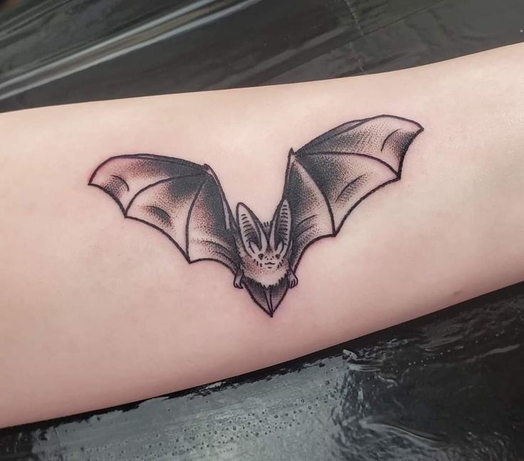 a bat tattoo is shown on the arm