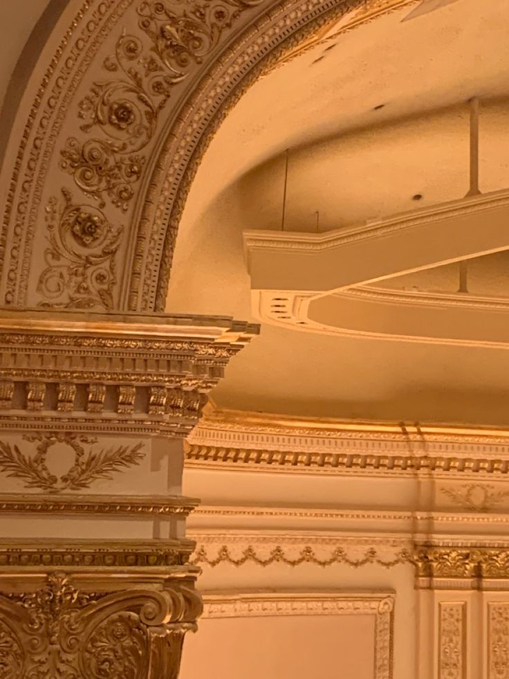 an ornately decorated ceiling in a building with gold trimmings and decorative moldings