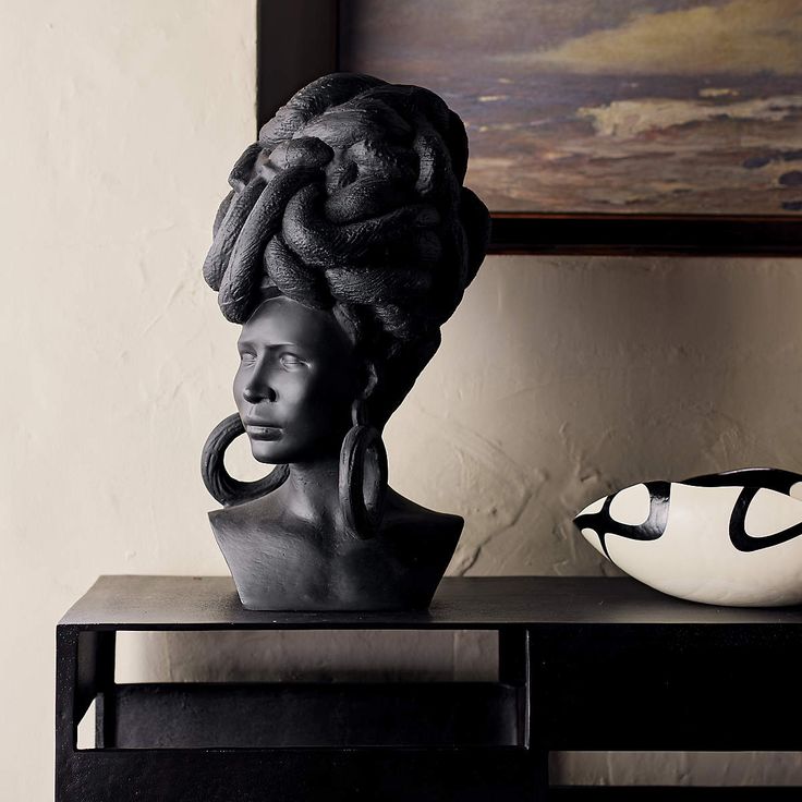 a black and white photo of a woman's head on a table next to a vase