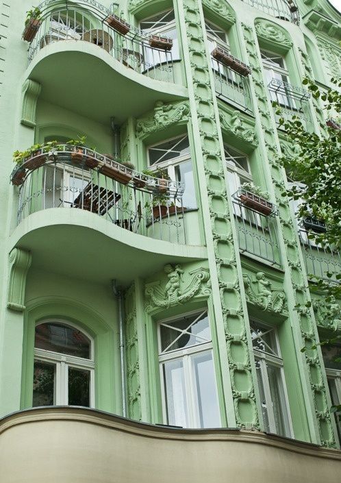 an apartment building with balconies and balcony railings on the second floor, in paris