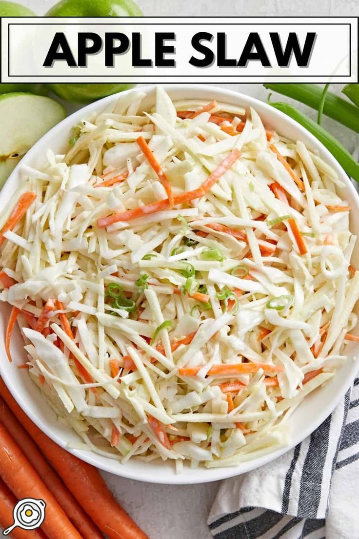 an apple slaw in a bowl with carrots and celery