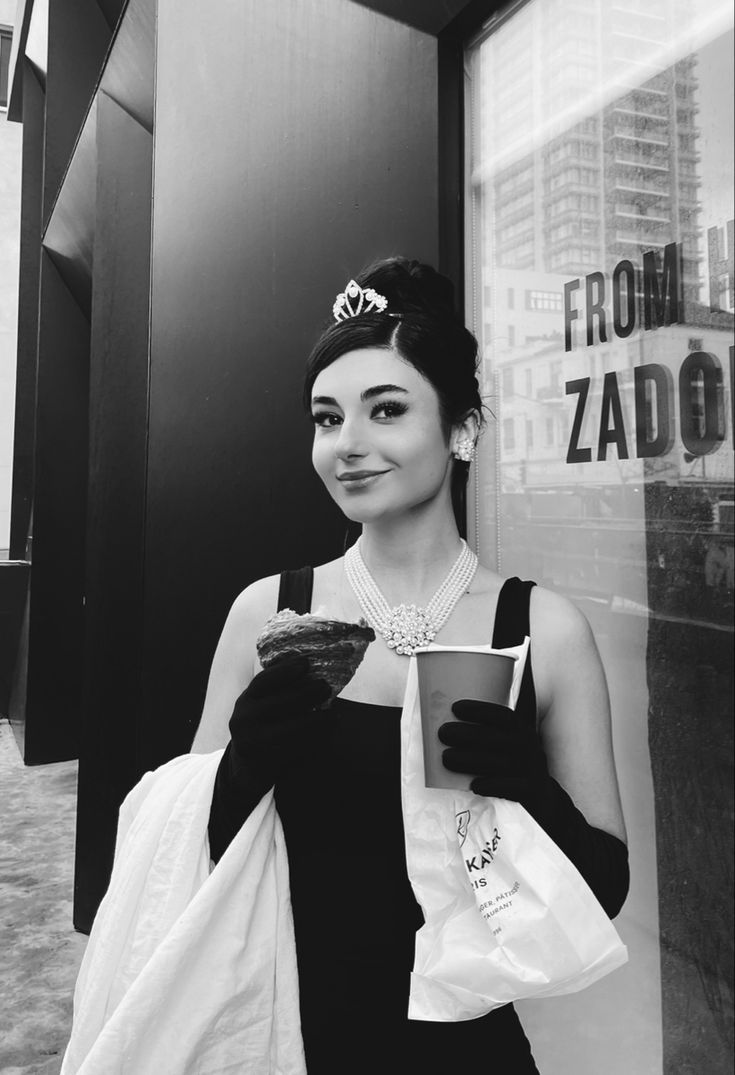 black and white photograph of a woman holding a book