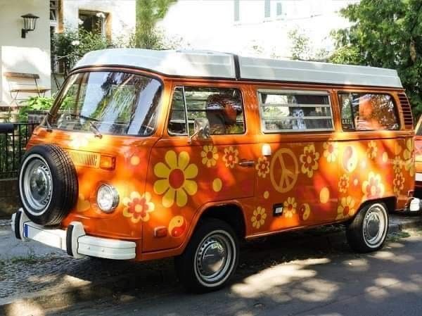 an orange van with flowers painted on it