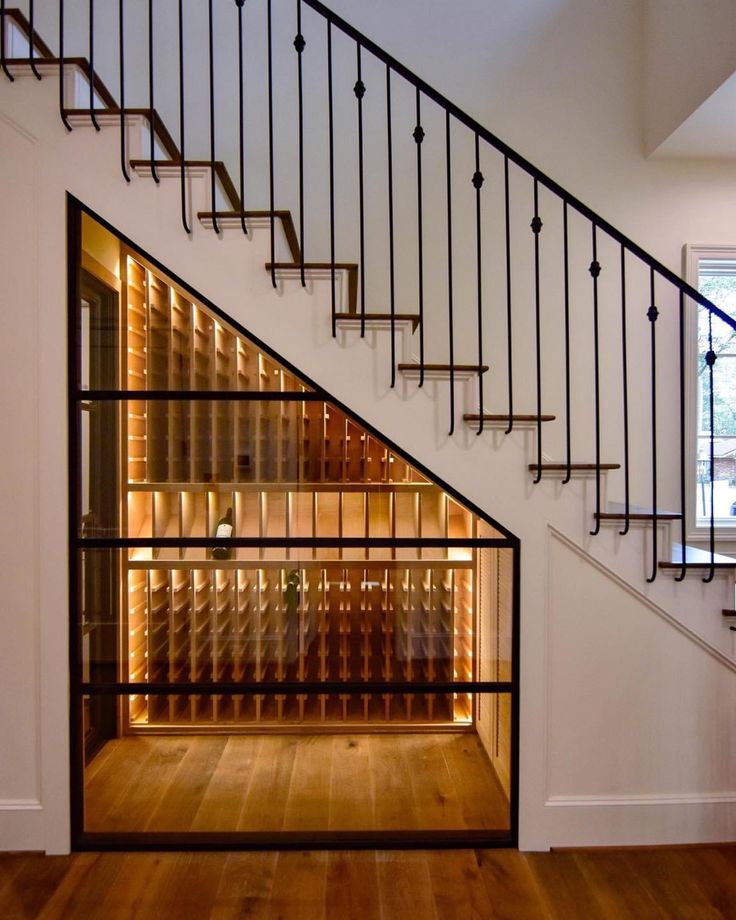 a staircase with glass shelves under it