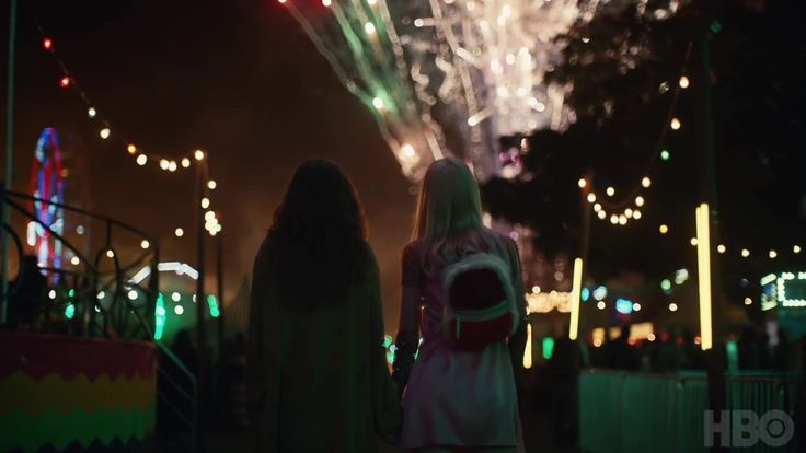 two girls looking at fireworks in the night sky