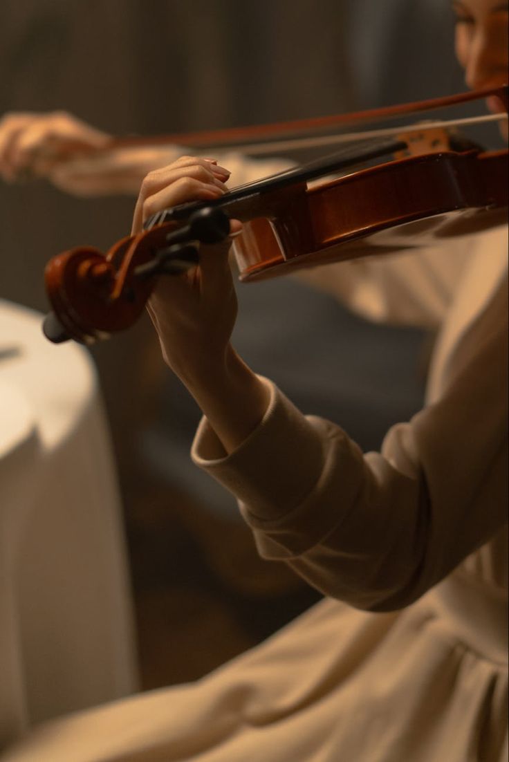 a woman holding a violin in her right hand