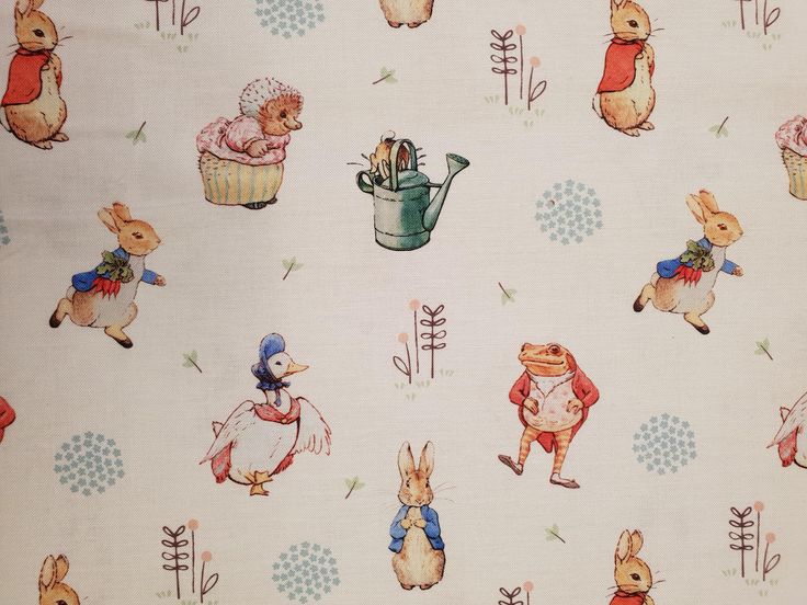 the fabric has rabbits and flowers on it