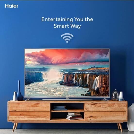 an entertainment center with a smart tv on it's stand in front of a blue wall that says, entertaining you the smart way