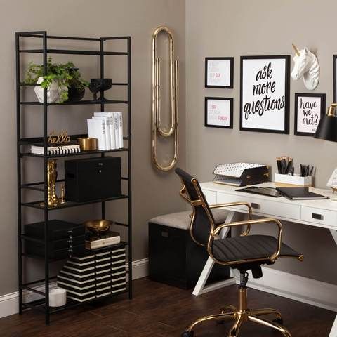 a room with a desk, chair and bookcase in it