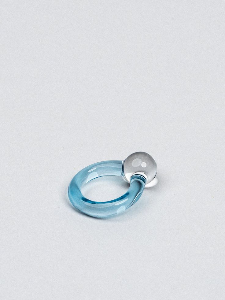 ✚ Inspiration The sweet topsy-turvy powers found in a solid glass marble + the simplicity of a blob of clear glass. This topsy-turvy marble sits on a coloured band - glimpses of colour come through the clear as the piece moves about on your hand. ✚ Process I flameworked this ring from clear borosilicate glass. The top of the ring is a solid clear bauble, and the ring band is made from translucent coloured glass. ✚ Size The large solid orb measures approximately 15mm, while the small orb measures Pebble Ring, Resin Rings, Topsy Turvy, Soldering Jewelry, Glass Ring, Coloured Glass, Resin Ring, Glass Marbles, Glass Rings