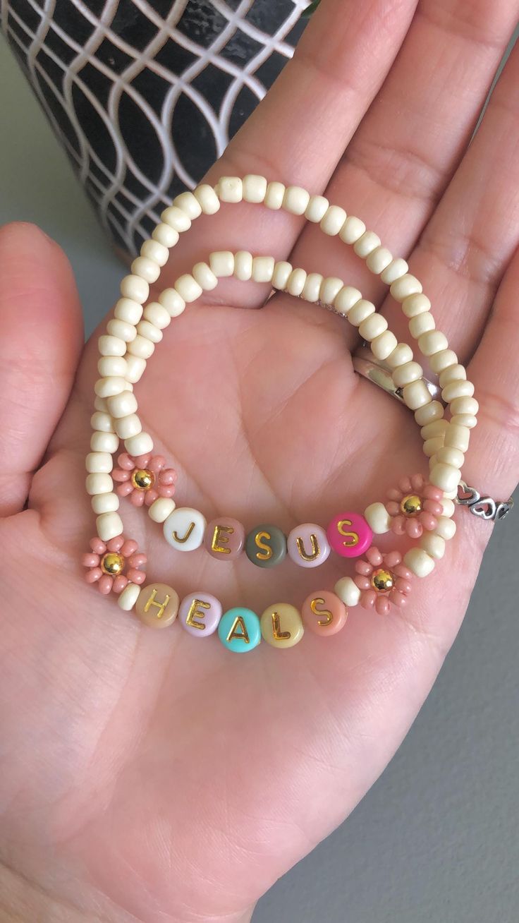 a person is holding some beads in their hand with the word bead on them