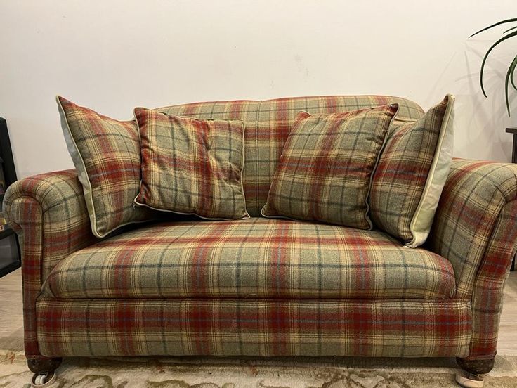 a plaid couch with two pillows on it