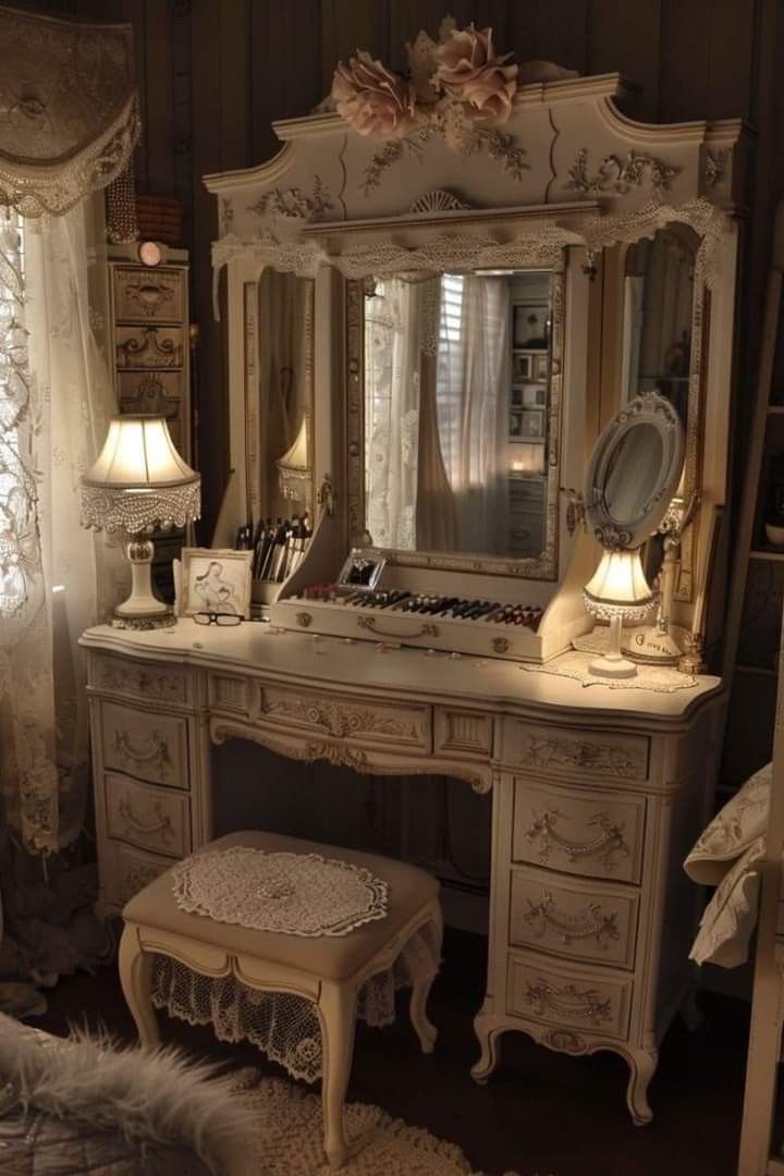 an antique vanity with stool and mirror in a bedroom