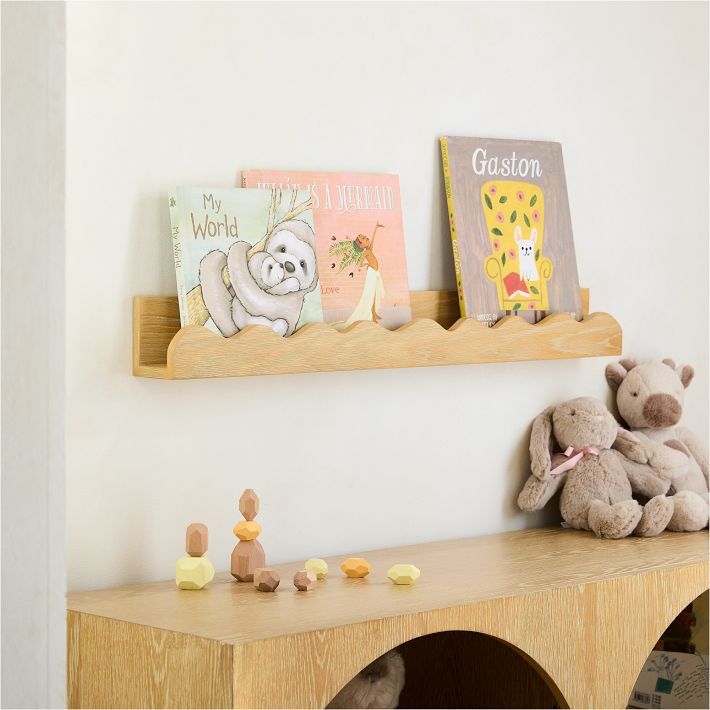 there is a shelf with books and stuffed animals on it in the corner, along with other children's toys